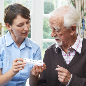 Nurse handing out pill case management of antipsychotic medications
