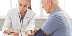 Standardised-care-process-doctor-checking-blood-pressure